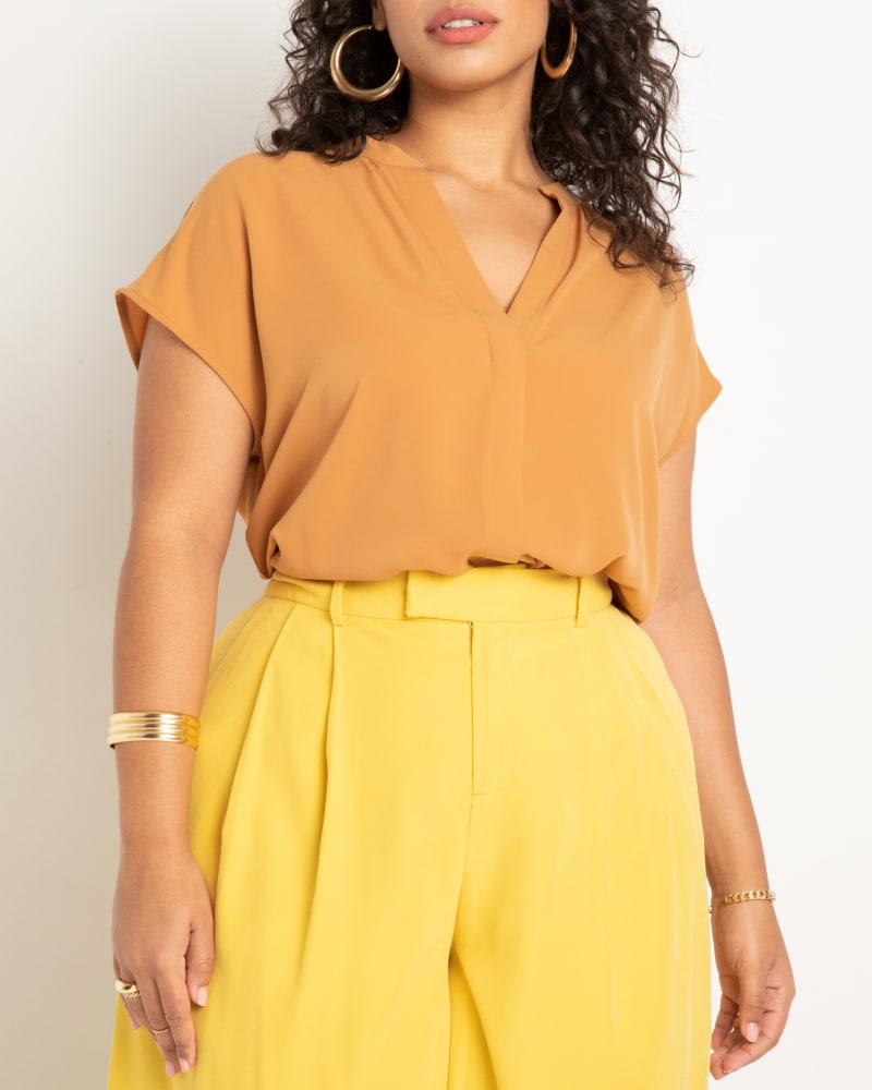 Front of a model wearing a size 16 Notch Collar Blouse in Biscuit by ELOQUII. | dia_product_style_image_id:272820